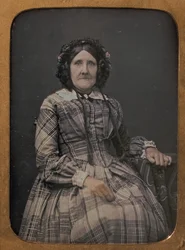 Zittende oudere vrouw met geruite jurk en muts, 1854-60